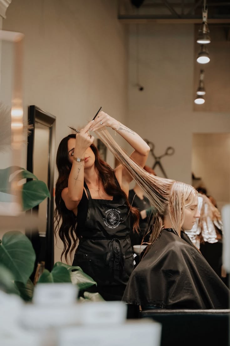 A hairstylist colouring a client's hair in a professional salon